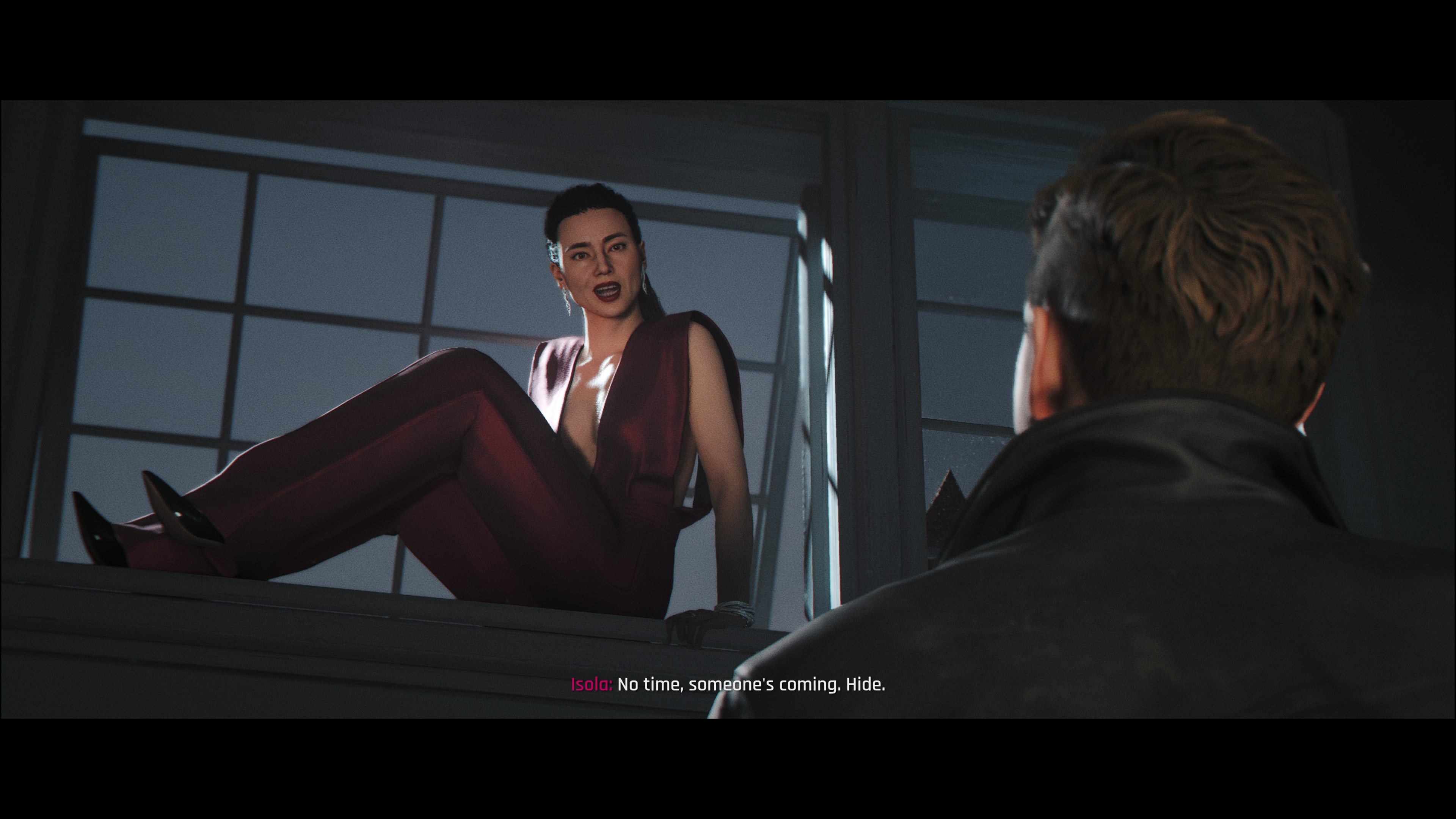 A screenshot of 007 First Light showing Bond speaking to Isola as she slips out of a basement window.