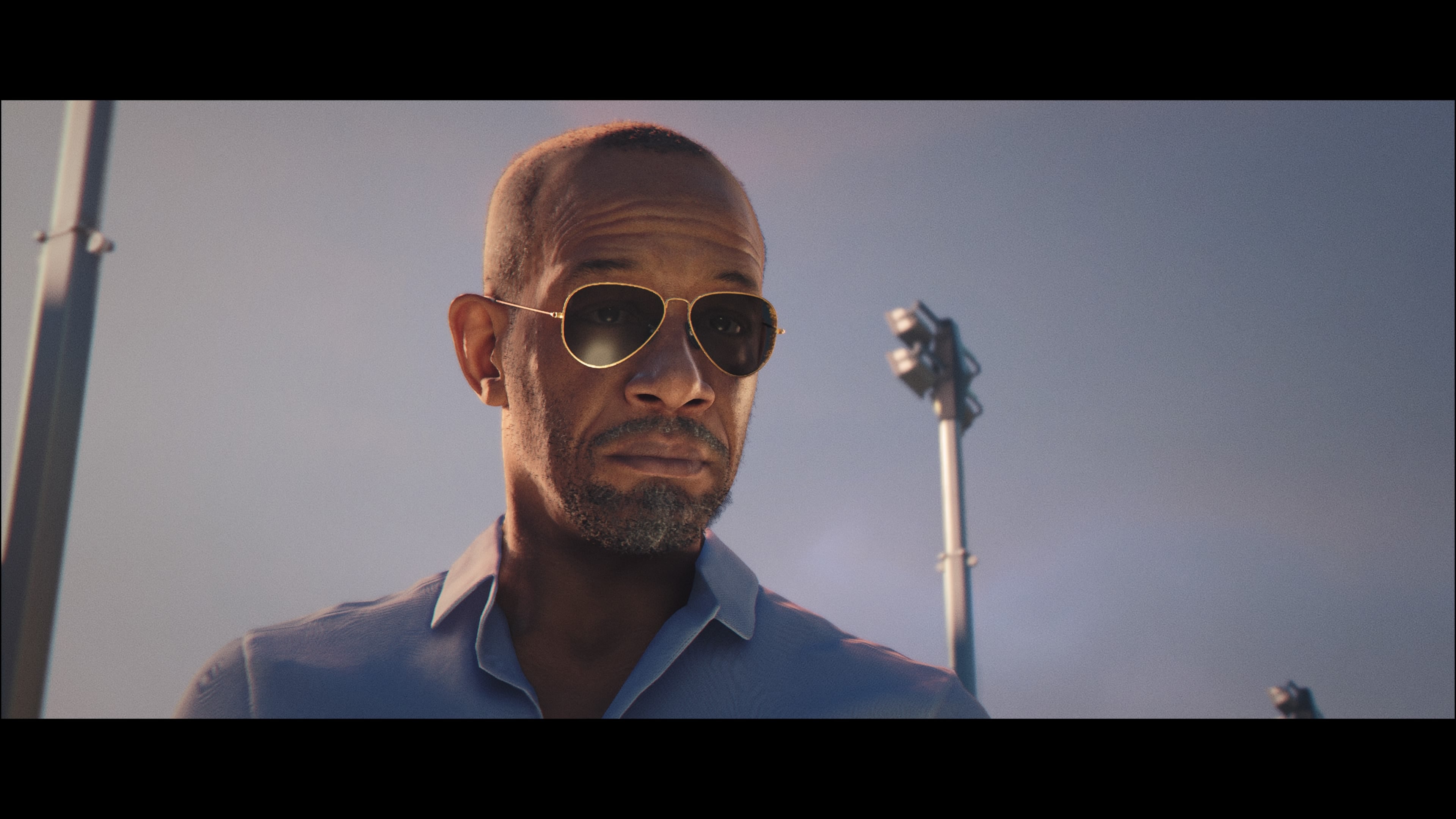 A screenshot of 007 First Light, showing John Greenway wearing sunglasses.