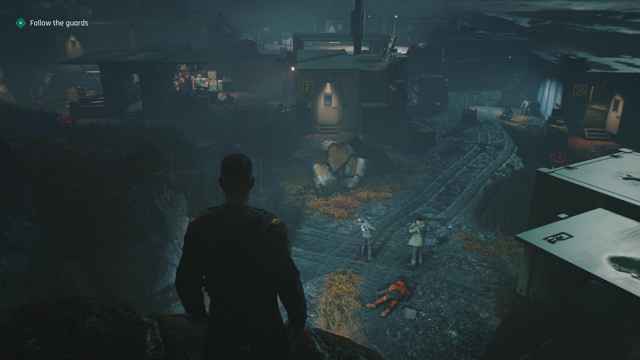 007 First Light screenshot showing Bond overlooking a camp of enemies at night, during the opening tutorial in Iceland