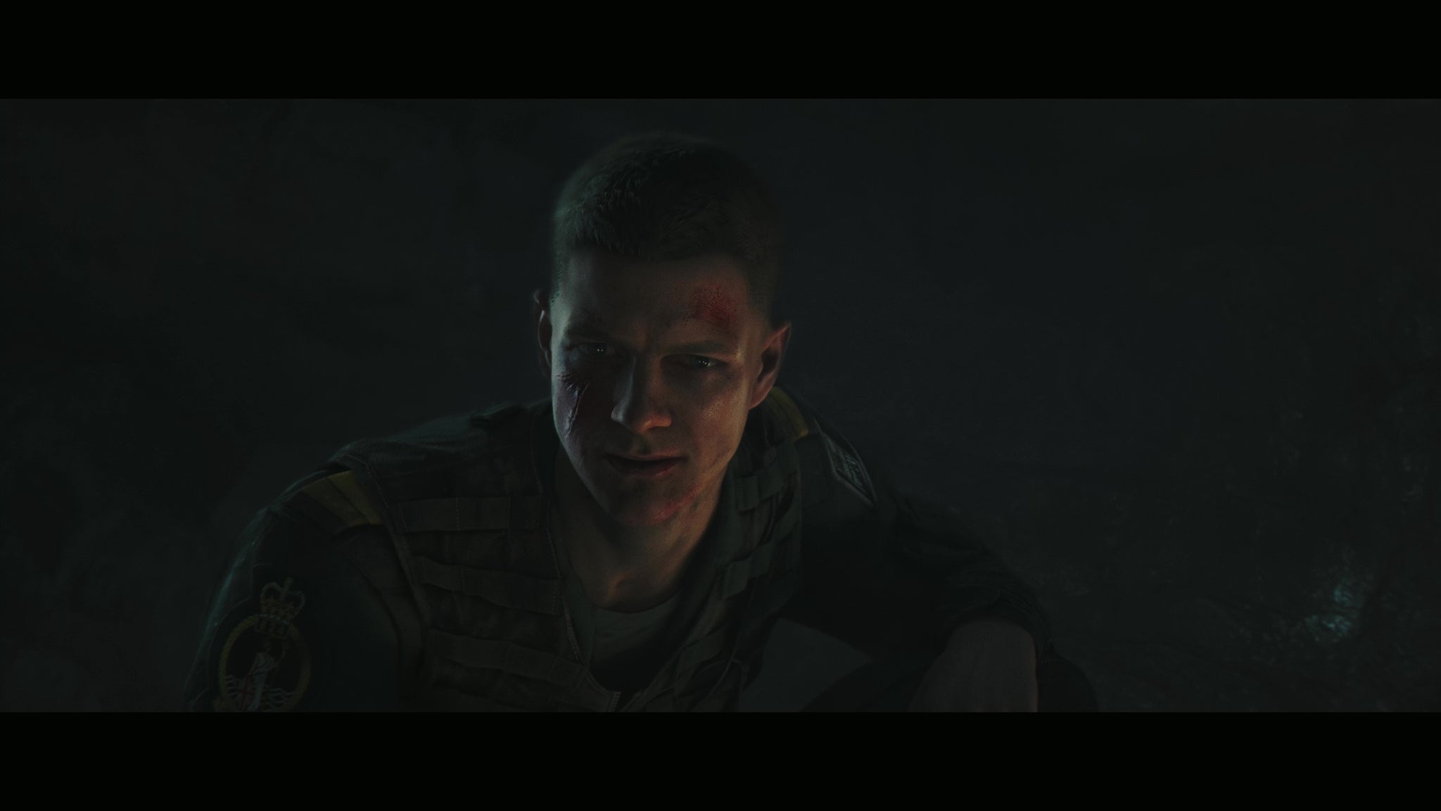 007 First Light screenshot showing Bond, in darkness, during a close up looking blodied and determined