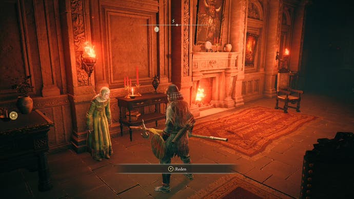 A warrior approaches an old woman in a green dress inside a cosy manor parlour room in Elden Ring