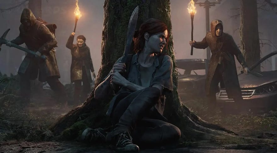 A woman hiding behind a tree with a machete while men with torches search for her in The Last Of Us Part 2
