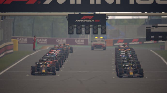 F1 Manager 2023 review screenshot, starting grid with 20 cars in position and safety car behind them.