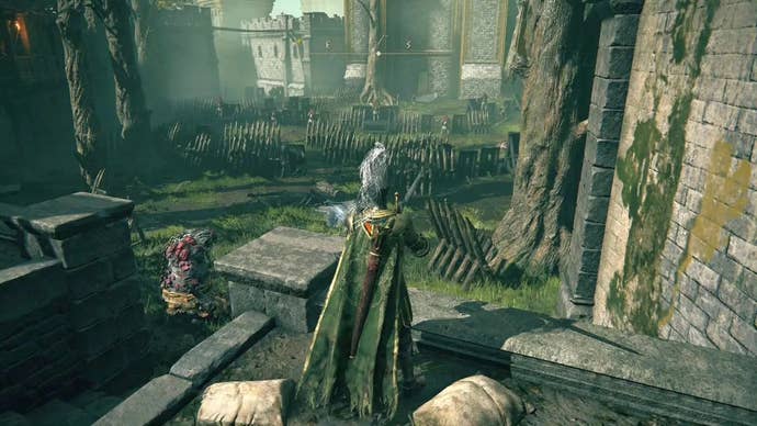 A knight stands on a ledge inside a grassy courtyard in Stormveil Castle in Elden Ring.