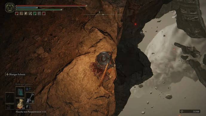 A warrior stands on the edge of a cliff in the Crumbling Farum Azula in Elden Ring.