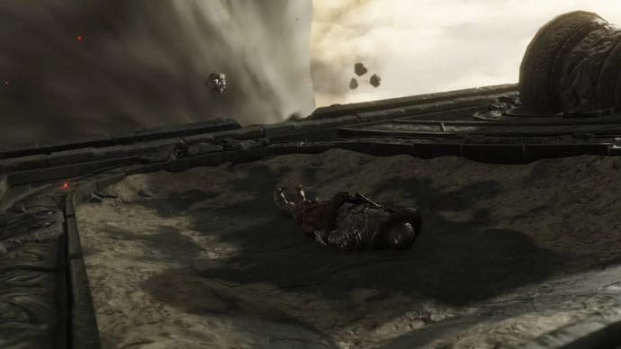 A warrior lies down on the ground in the Crumbling Farum Azula in Elden Ring.