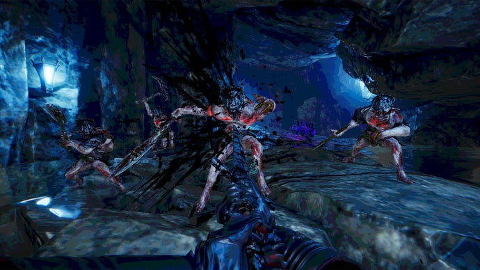 Monstrous creatures approaching the view in a cave system with blue light