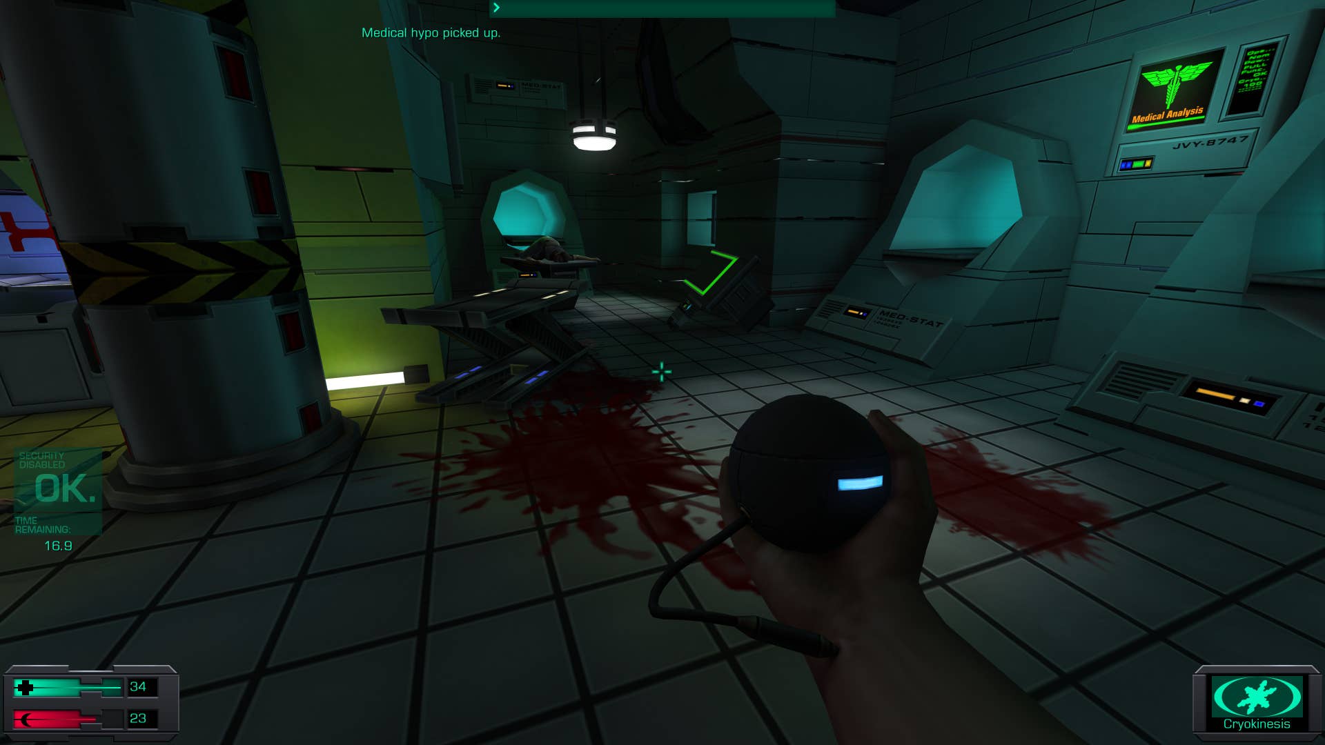 10. A screenshot of System Shock 2: 25th anniversary remaster, showing a medical bay littered with gurneys, the floor covered in blood.