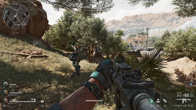 A screenshot of Delta Force: Hawk Ops, showing the player moving tactically through vegetation with their squad.