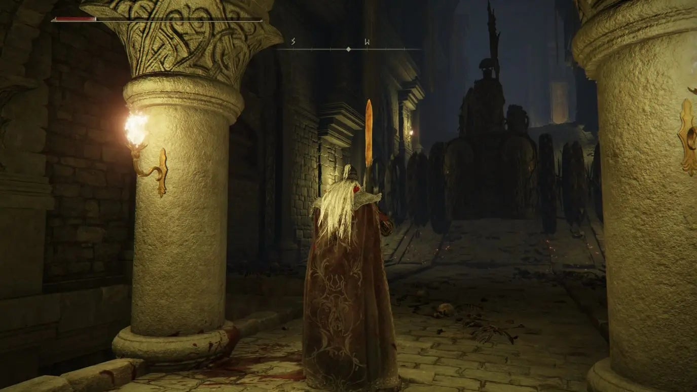 A warrior stands between two pillars in Auriza Hero&rsquo;s Grave in Elden Ring.