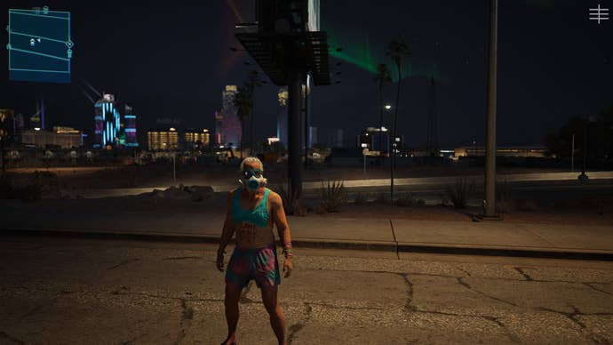 A screenshot of MindsEye, showing the free roam protagonist standing on a road, Redrock city in the background.