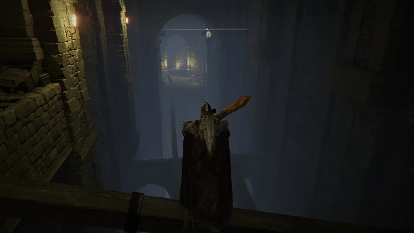 A warrior looks out over a misty abyss inside Auriza Hero&rsquo;s Grave in Elden Ring.