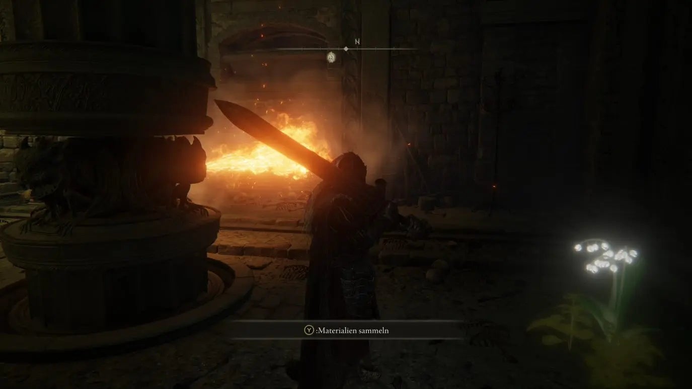 A warrior stands behind a flaming wooden pillar in Auriza Hero&rsquo;s Grave in Elden Ring.