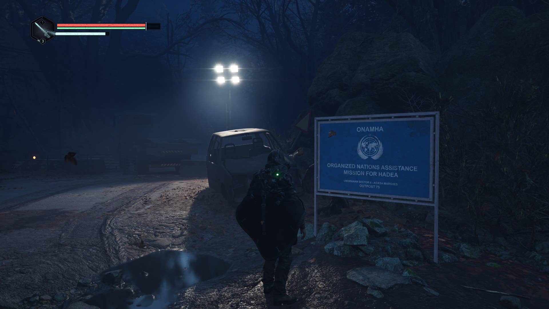 A third view of a man in a black hooded poncho looking at a blue sign reminiscent of a UN iconography on a muddy dark road. Hell is us from video games.