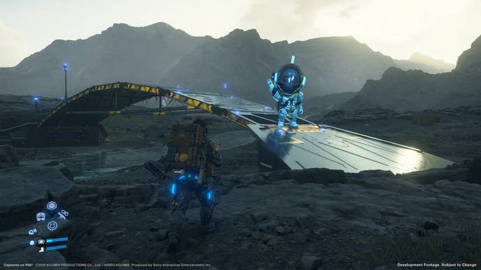 Death Stranding 2 screenshot showing Sam approaching a player-made bridge with a spaceman character on it