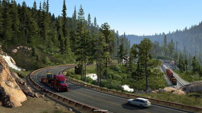 A screenshot of American Truck Simulator’s Montana expansion, showing a curved road, a truck, and a lotta trees.