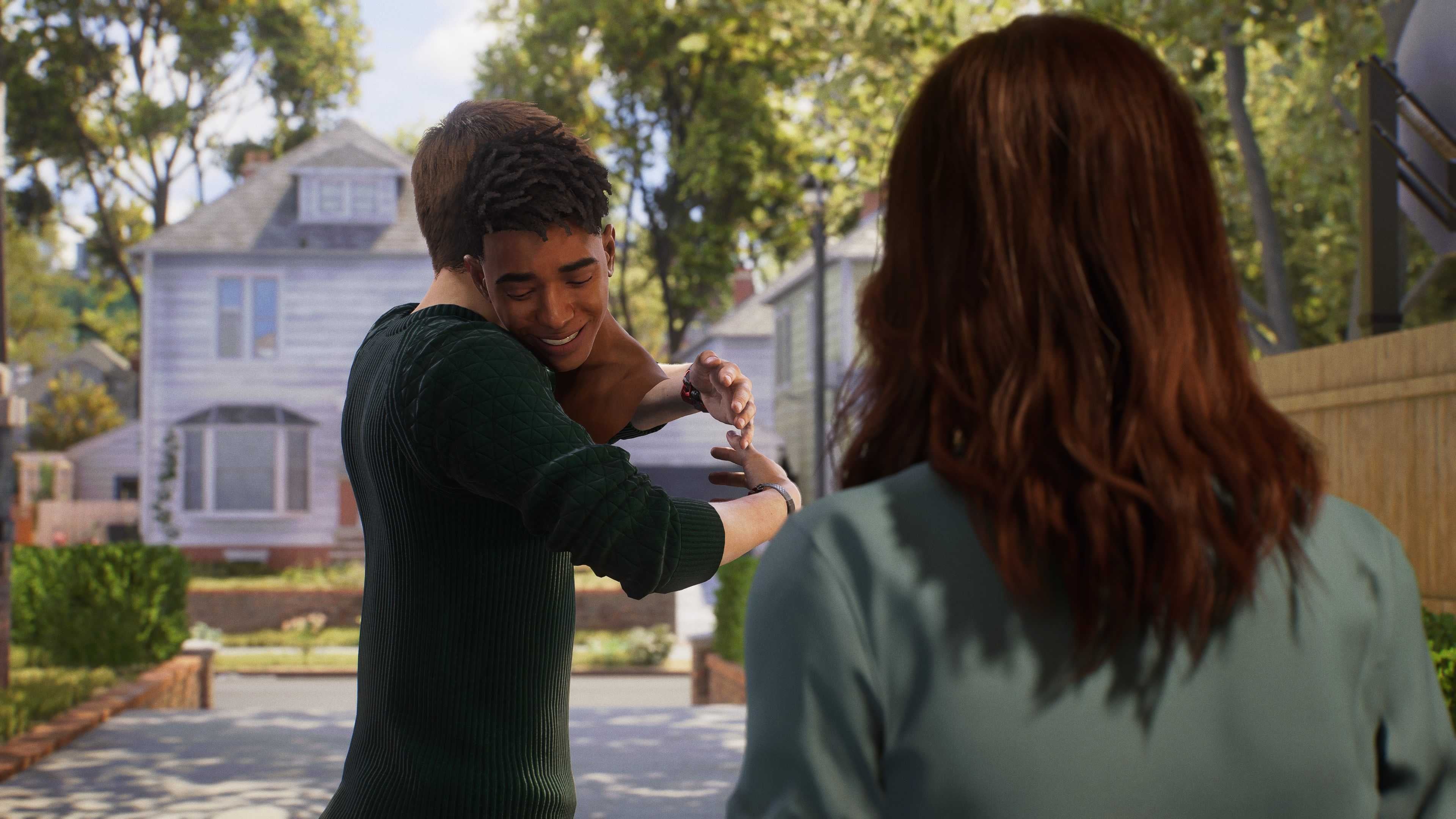 Miles Morales and Peter Parker hug at the end of Marvel&rsquo;s Spider-Man 2, as MJ watches on. My game glitches so Miles is just a head.