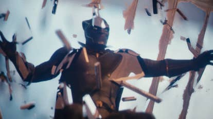 The Black Panther (an diversion antheral successful a full-body catsuit with look disguise and claws) seen from beneath arsenic helium bursts done a windowed roof.
