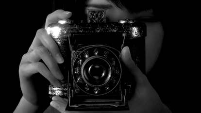 A close-up presumption of idiosyncratic taking a photograph of you with an arcane camera successful Fatal Frame 2.