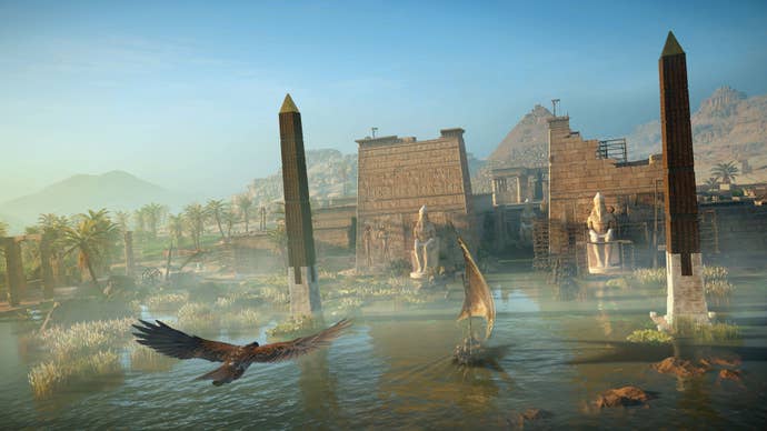 A temple and obelisks jutting out of a blue river with trees behind and hazy hills and an eagle flying in the foreground. From Assassin’s Creed Origins.