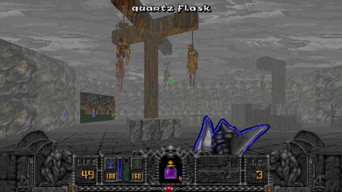 A screenshot of Hexen: Vestiges of Glory, showing the player character looking at a gibbet festooned with corpses in a misty landscape.