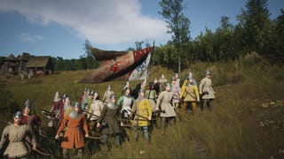A line of soldiers in Manor Lords crossing the countryside with a flag