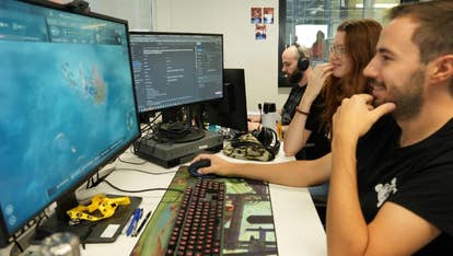 Female and antheral developers astatine Amplitude looking astatine Endless Legend 2 connected a machine screen.