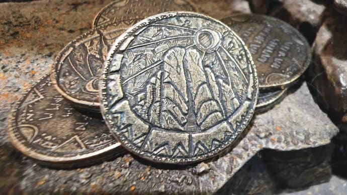 Some coins with fantasy engravings on them from the Witcher universe