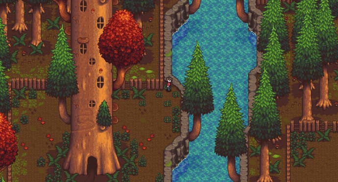 An autumnal riverside from Haunted Chocolatier, showing a immense histrion with doors and windows and smaller greenish fir trees.