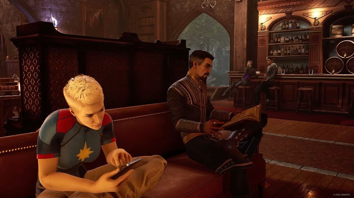 2022 best games Marvel&rsquo;s Midnight Suns - Dr Strange and Captain Marvel read books and phones respectively on the sofa