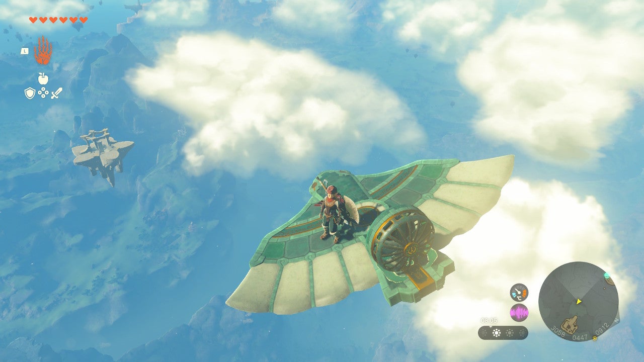 Link flying a Zonai fan-powered glider towards a sky island in The Legend of Zelda: Tears of the Kingdom.