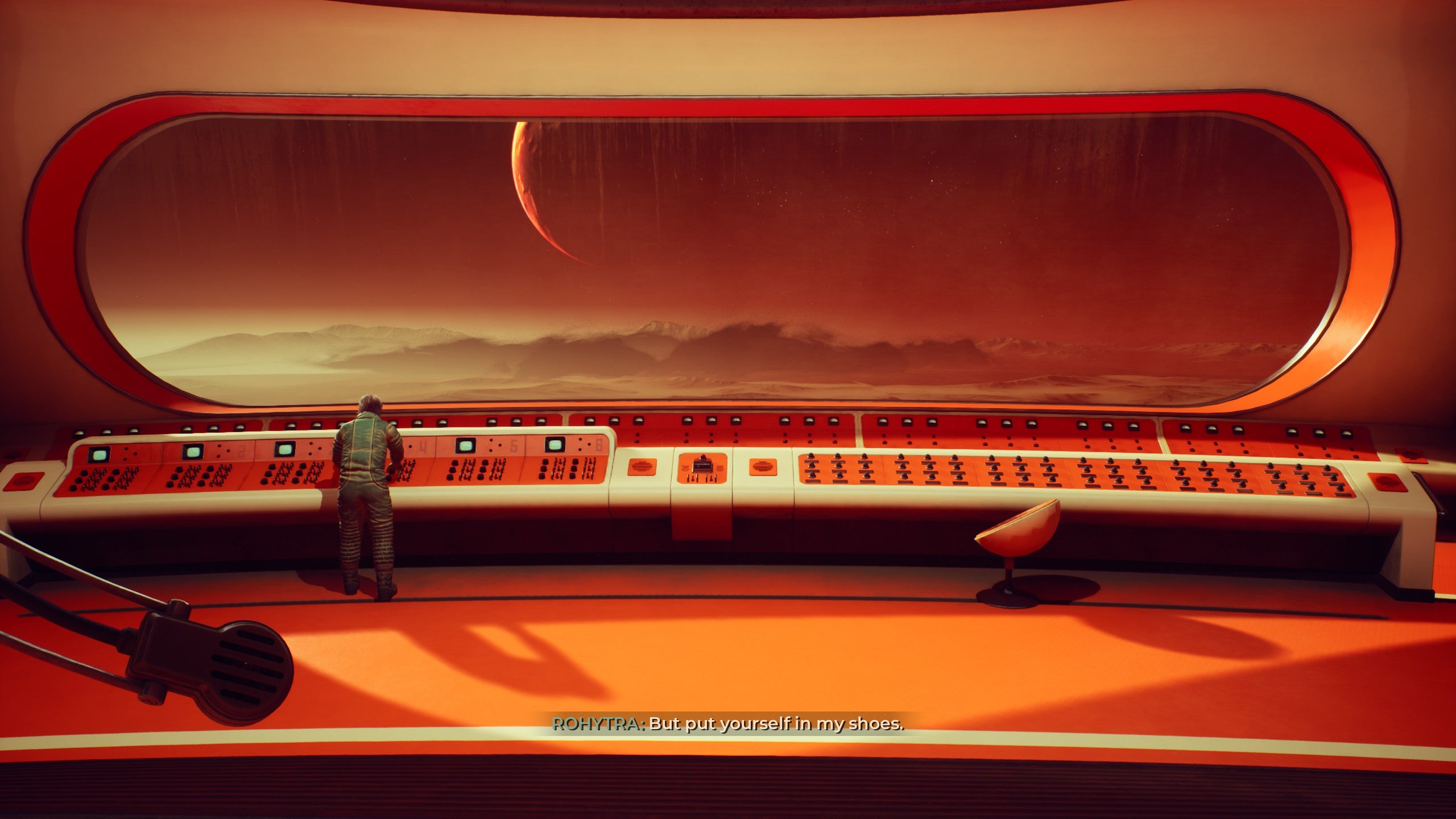 A huge oblong window and control desk in an impossibly sleek and retro designed spaceship. It's The Invincible.
