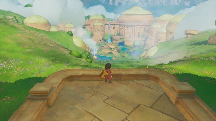 A boy looking from the top of a hill down to a large crop of buildings surrounding a lake in Europa