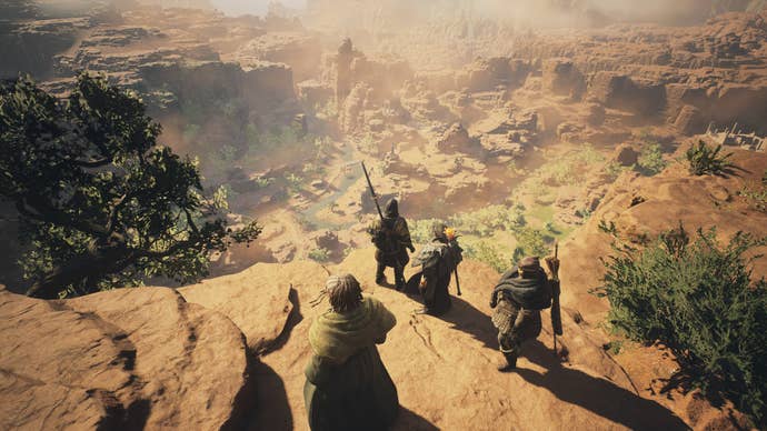 An Arisen and a group of pawns look out over the orange landscapes of Battahl in Dragon’s Dogma 2.