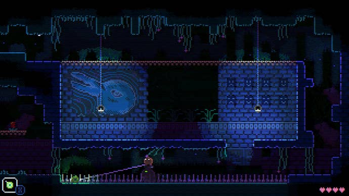 An area in Animal Well with brick walls bearing images of a creature and dangling lanterns