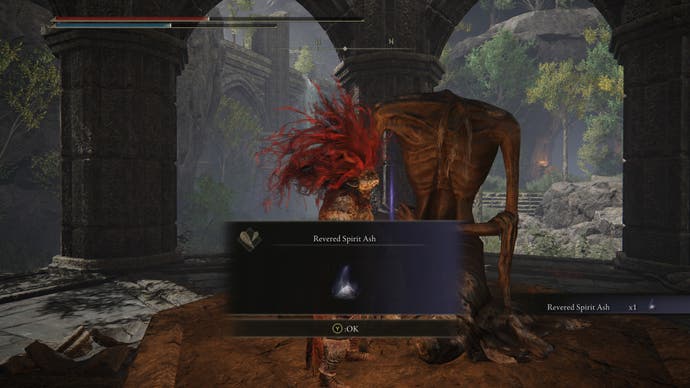 A warrior obtains a Revered Spirit Ash from a statue in the Ancient Ruins of Rauh in Elden Ring Shadow of the Erdtree.