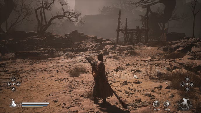 A monkey warrior stands in a sandy scene with a bridge in the distance in Black Myth Wukong.