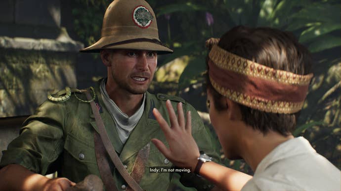 Gina holds up her hand and tells Indy to stop moving as a snake crawls over his shoulder in Indiana Jones and the Great Circle.