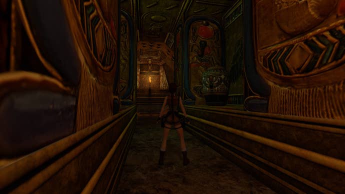 Lara Croft stands in a narrow corridor in a tomb in Tomb Raider 4-6 Remastered.