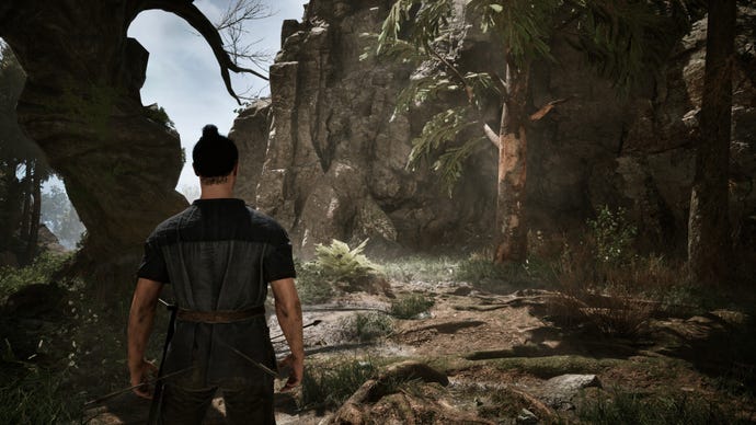 A man with two arrows sticking out of his bum in a forested rocky area in the Gothic remake