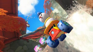 A snowman clears a waterfall in Mario Kart World.