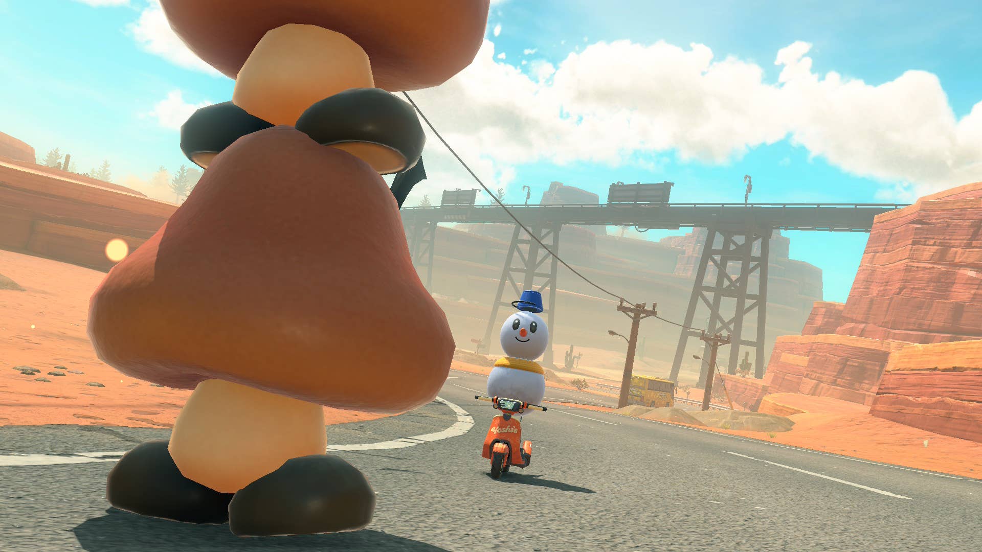 A snowman faces a tower of goombas in Mario Kart World.