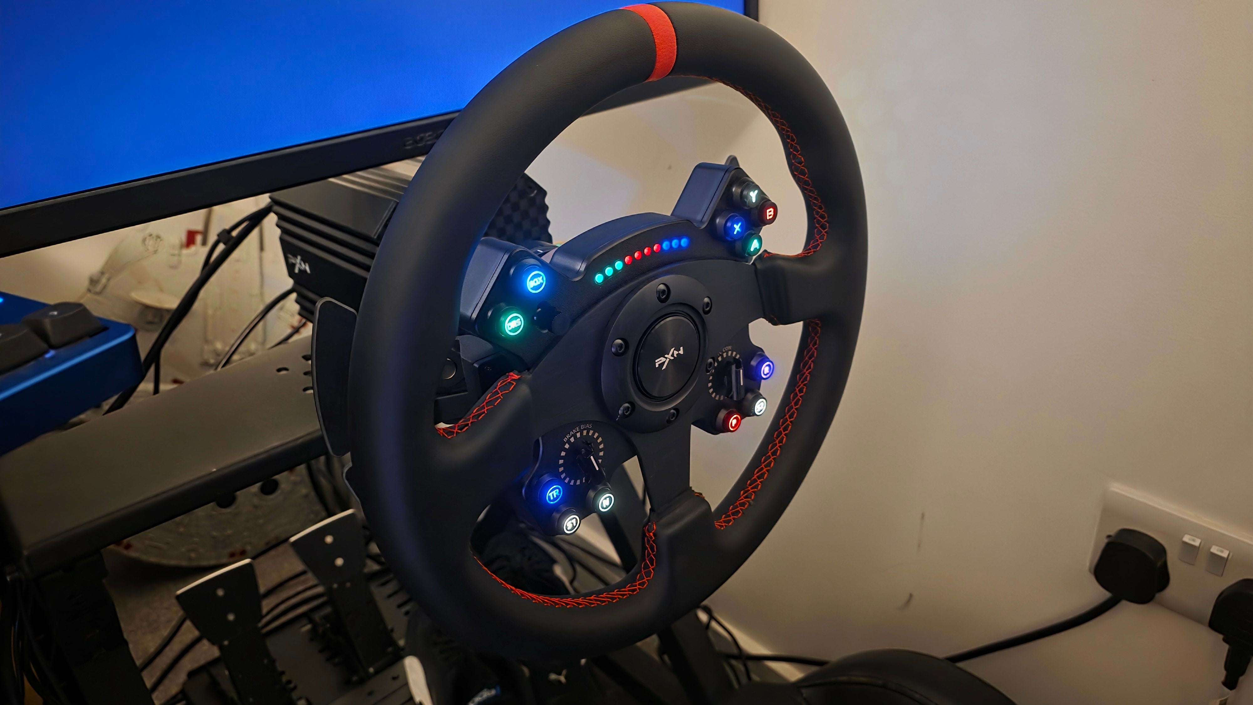 A close-up view of the PXN VD10 direct drive sim racing wheel base with a modern GT-style racing wheel attached, showcasing its sleek black design, robust construction, and clearly visible buttons and paddle shifters, set against a blurred background of a sim racing cockpit, emphasizing the detailed force feedback technology for an immersive experience.