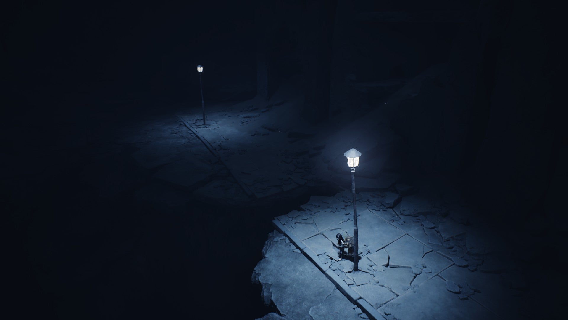 An underground street with huge pitfalls and glowing lamp posts in Reanimal.