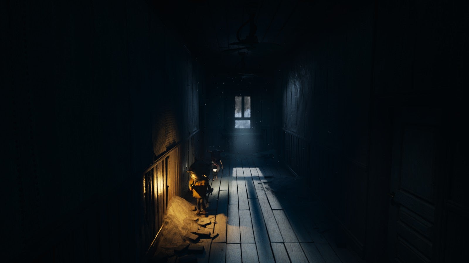 A long hallway with light shining through windows at the end in Reanimal, and two kids running through the shadows to one side.