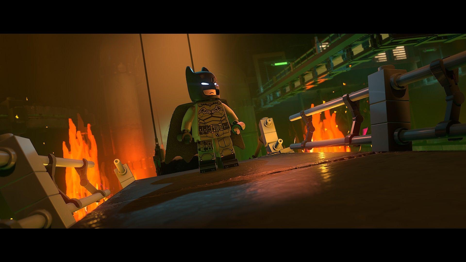 Lego Batman: Legacy of the Dark Knight screenshot showing Batman looking heoric amongst flames