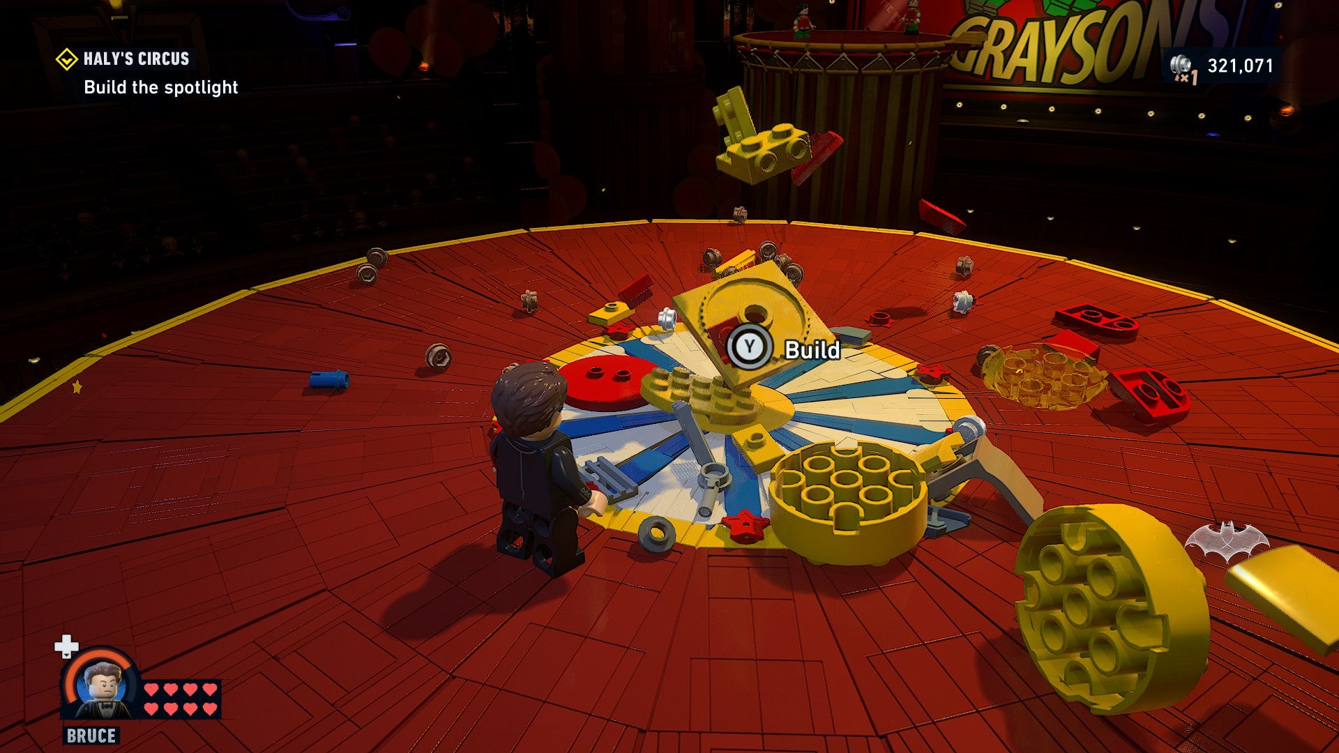Lego Batman: Legacy of the Dark Knight screenshot showing Batman with a load of Lego pieces