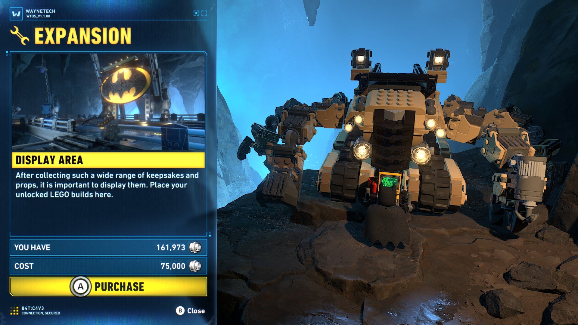 Lego Batman: Legacy of the Dark Knight screenshot showing Batman interacting with a large machine with the option to expand the Batcave area