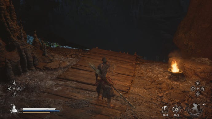 The Destined One stands before a wooden drop in Black Myth: Wukong’s Webbed Hollow.