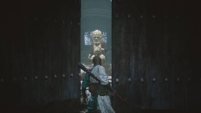 Elder Jinchi is framed by two doors in the Ancient Guanyin Temple of Black Myth: Wukong.